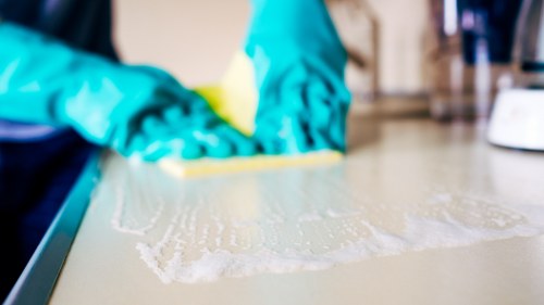 Close-up view of an oven cleaner in Kennington removing grease and grime